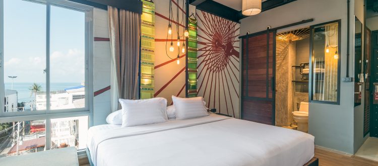 Bed with sea view in the Chiang Mai styled room of Sea Crest By Jomtien Hotel in Jomtien Beach-Pattaya, Thailand